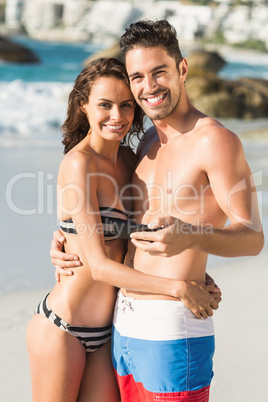 Couple posing and holding smartphone