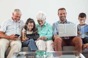 Happy family sitting on sofa