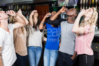 Group of friends drinking shots