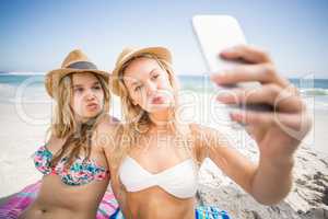 Two friends in bikini taking a selfie