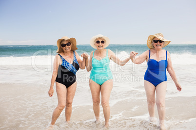 Senior woman friends playing in water