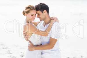 Young couple embracing on the beach