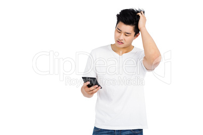 Worried man doing calculations on a calculator