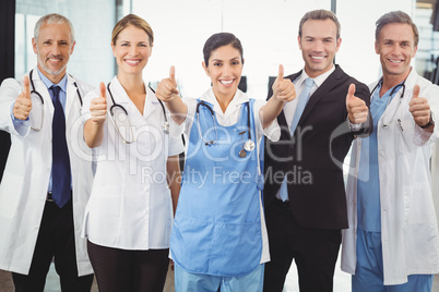 Medical team putting their thumbs up and smiling