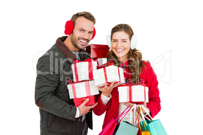 Happy young couple holding gifts and shopping bags