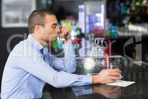 Worried businessman drinking whisky