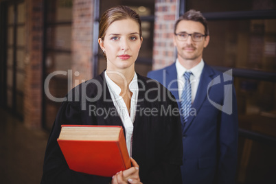 Confident female lawyer with businessman in office