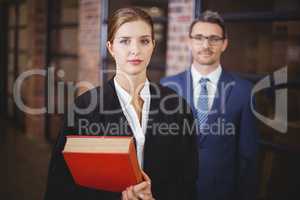 Confident female lawyer with businessman in office