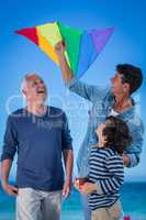 Happy multi generation family playing with a kite