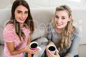 Portrait of beautiful female friends drinking coffee