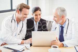 Medical team using laptop in conference room