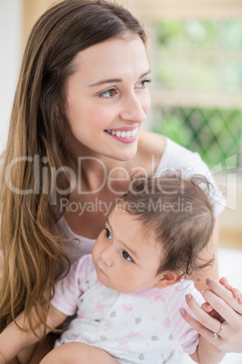 Smiling mother with toddler at home