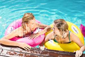 Happy friends enjoying in the swimming pool