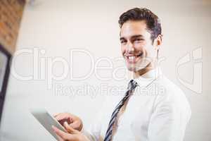 Portrait of smart businessman using digital tablet