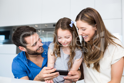 Man showing smart phone to family