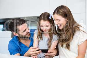 Man showing smart phone to family