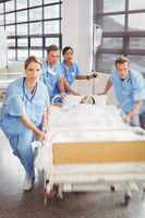 Group of doctors carrying woman patient