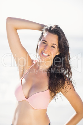 Portrait of pretty woman in bikini standing on the beach