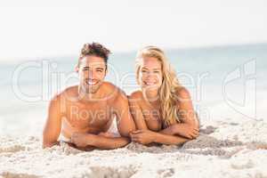 Young couple lying on sand