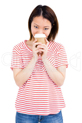 Happy woman holding disposable coffee cup