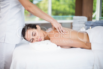 Woman receiving back massage from female masseur