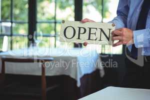 Businessman holding open sign