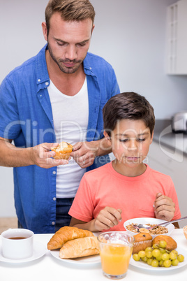 Father and son having breakfast
