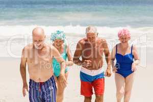 Senior friends getting out of water