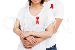 Midsection of man and woman with red ribbon
