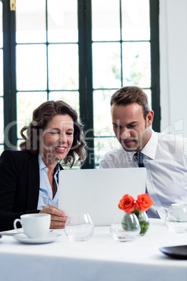 Business colleagues using a laptop while having a meeting