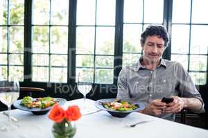 Man in a restaurant using mobile phone