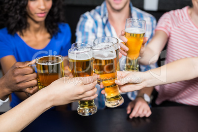 Happy friends drinking beer and toasting