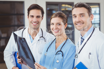 Portrait of happy doctors holding X-ray