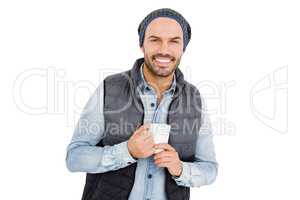 Happy young man holding coffee mug