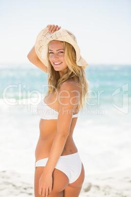Smiling woman standing at the beach