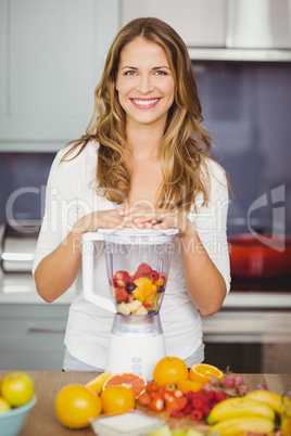 Portrait of smiling woman with juicer