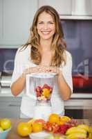 Portrait of smiling woman with juicer