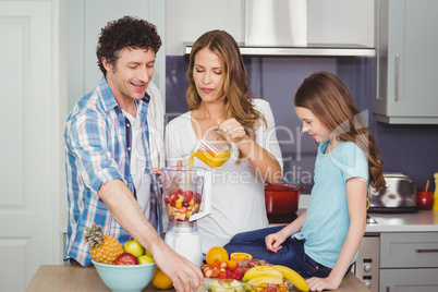 Family preparing fruit juice