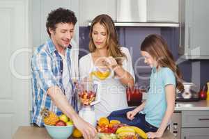 Family preparing fruit juice