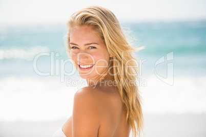 Smiling woman posing at the beach