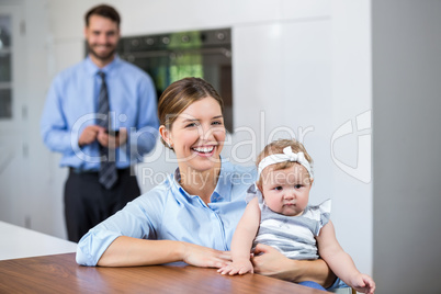 Woman with daughter while man standing in background