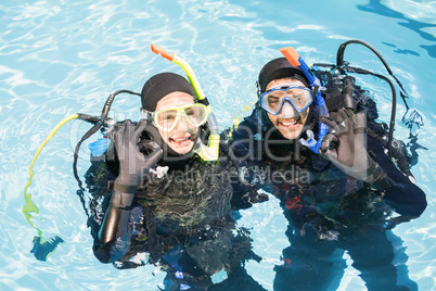 Couple practicing scuba diving together