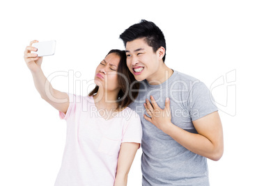 Young couple taking a selfie on smartphone