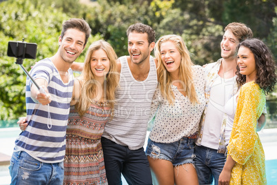 Group of friends taking a selfie near pool