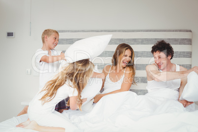 Playful family on bed at home