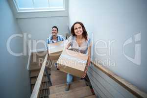 High angle view of smiling couple holding cardboard boxes while