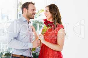 Man offering flower bouquet to woman