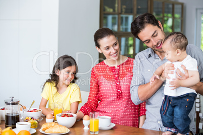 Smiling family at breakfast table