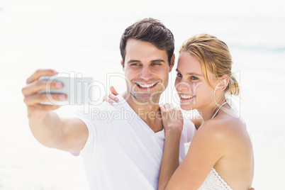 Couple taking a selfie on the beach