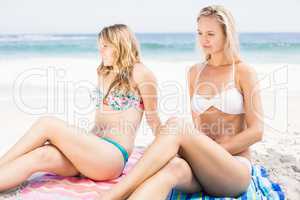 Pretty women in bikini sitting on the beach